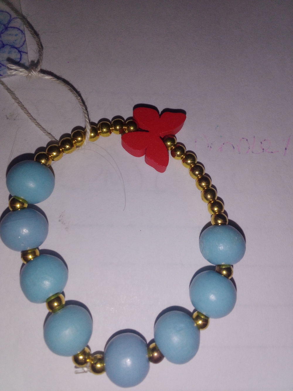 Blue Beaded Bracelet with Red Butterfly Accent